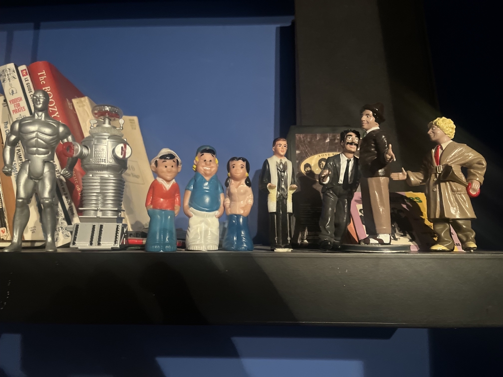 A shelf with toy figurines and mementos